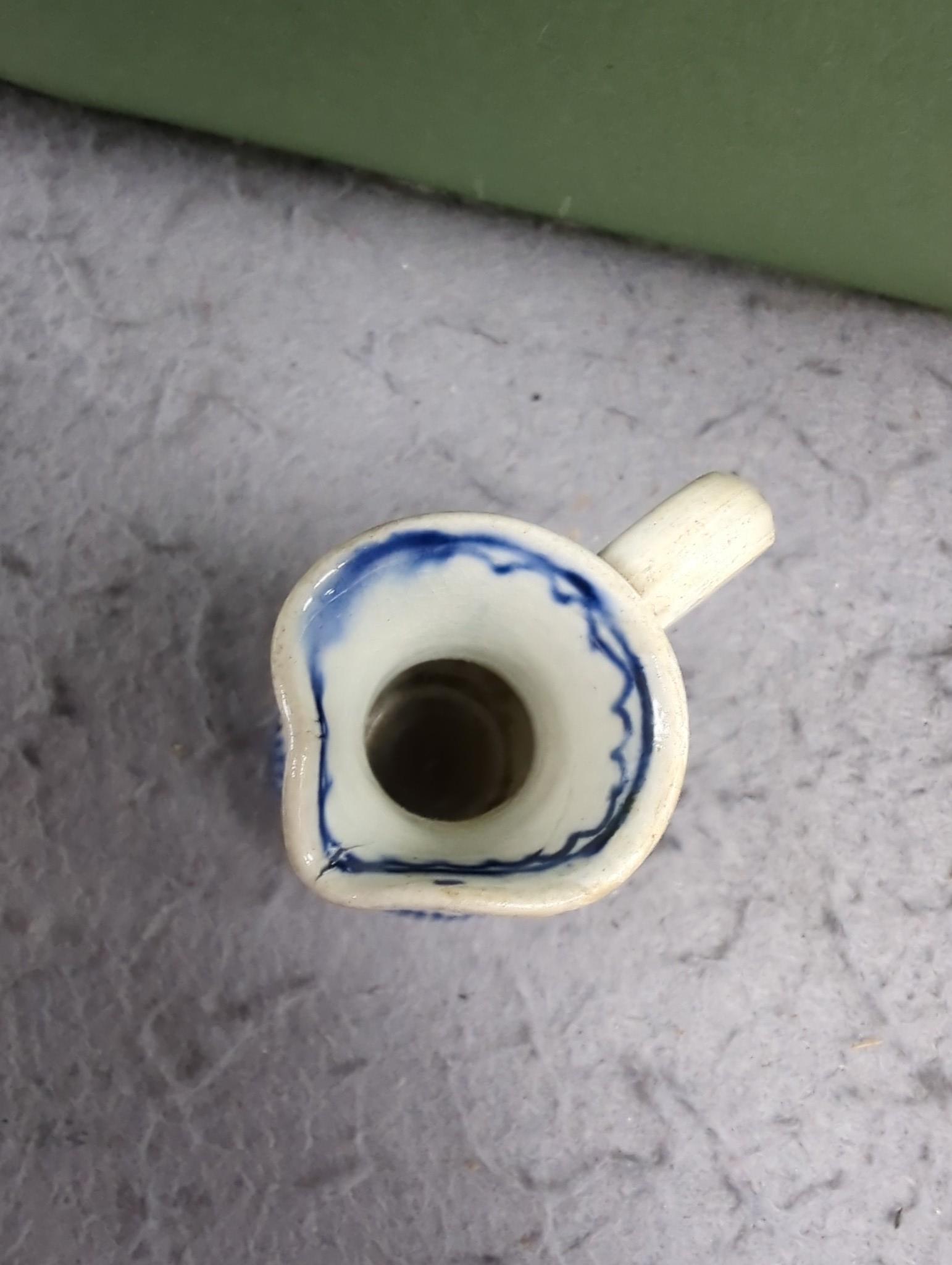 A late 18th century pearlware blue and white miniature jug, 5cm, and tea bowl and an English porcelain miniature mug, late 18th century